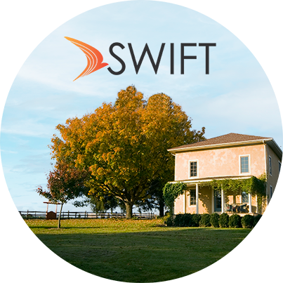 Rural home with overlay of SWIFT logo at the top of the image.